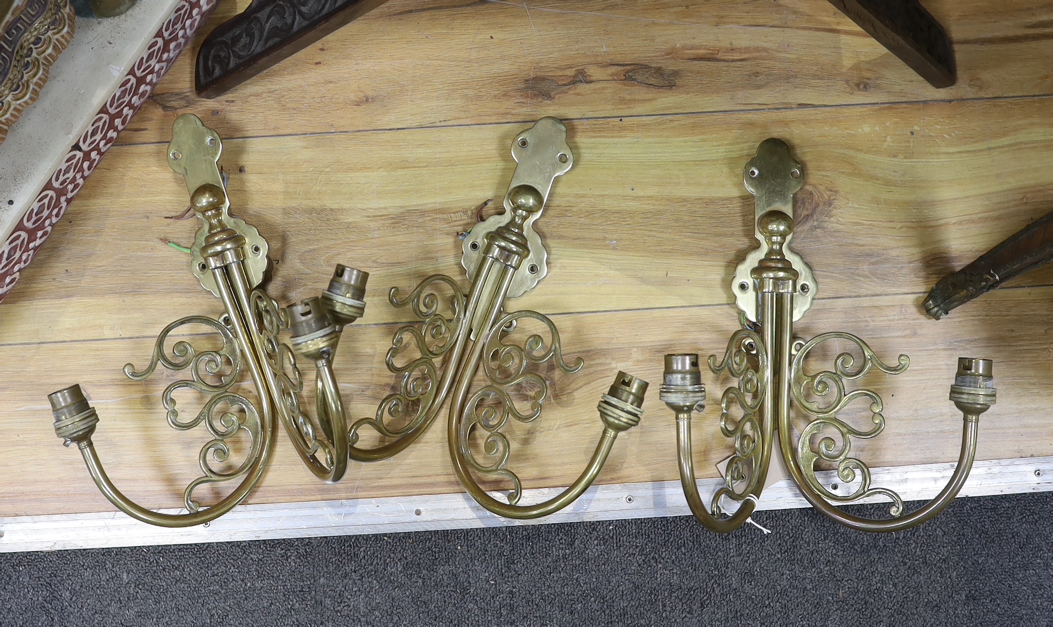 A Dutch style brass chandelier and three brass wall sconces